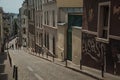 MontmartreÃ¢â¬â¢s slope street with semi-detached buildings in late afternoon sunny day at Paris.